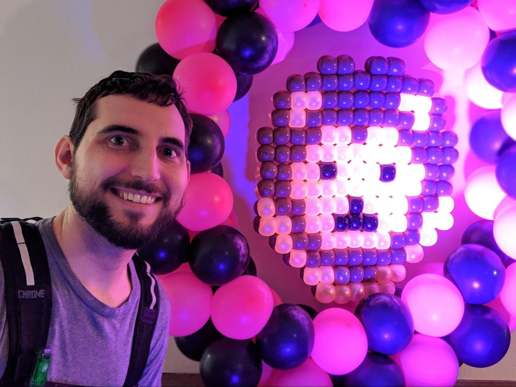 Tim in front of a lion sprite, constructed with balloons